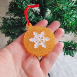 Boule de Noël en résine dorée nacrée et motif flocon.