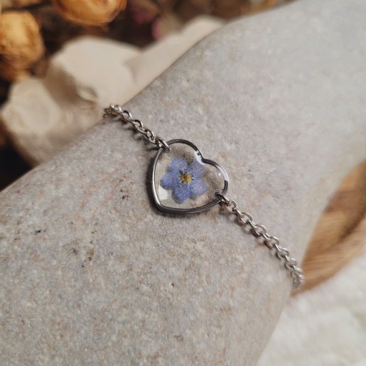 Bracelet en acier inoxydable et pendentif coeur avec fleur séchée de Myosotis.
